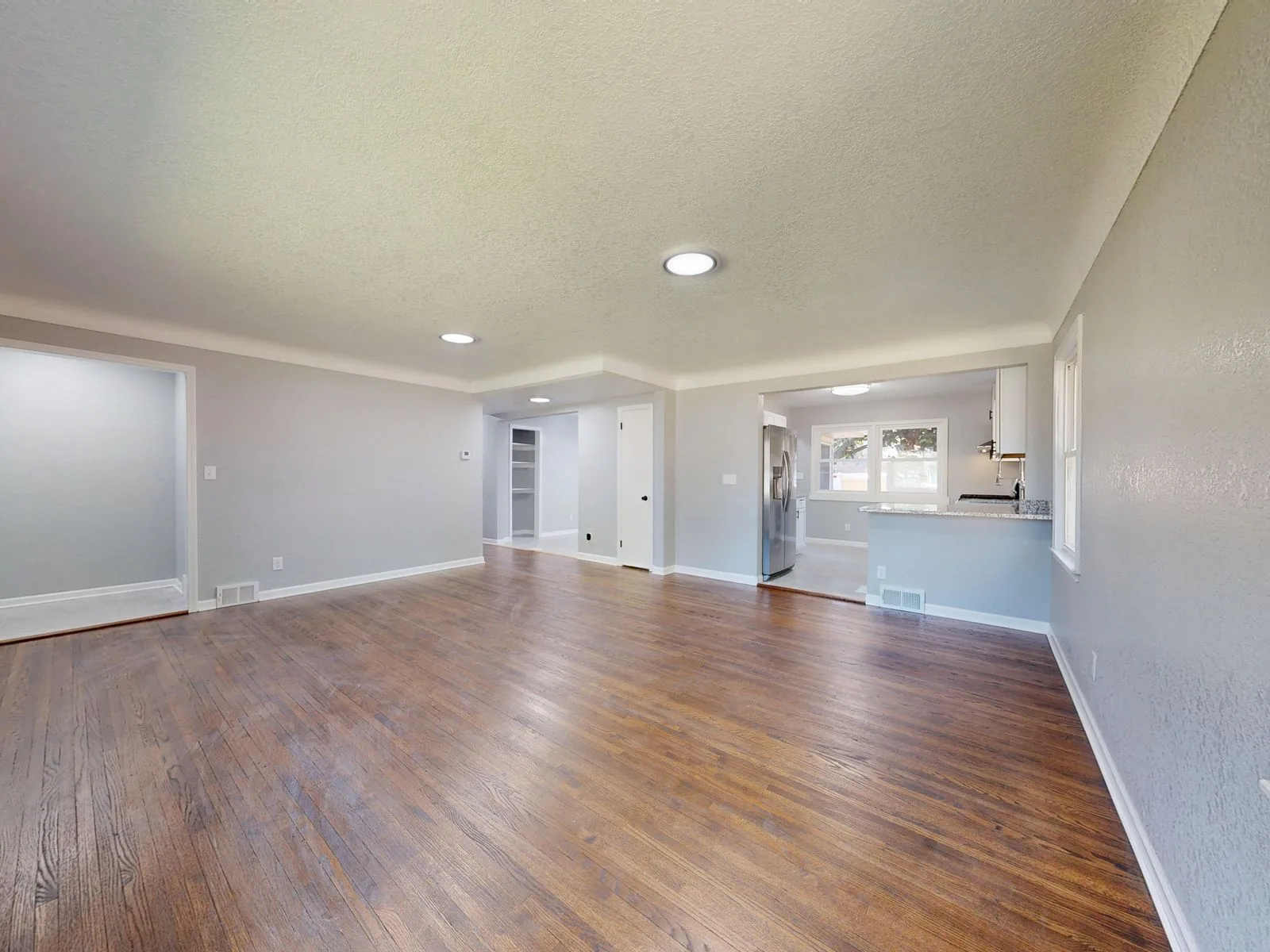 Room with newly installed hardwood flooring with clean, modern finishes