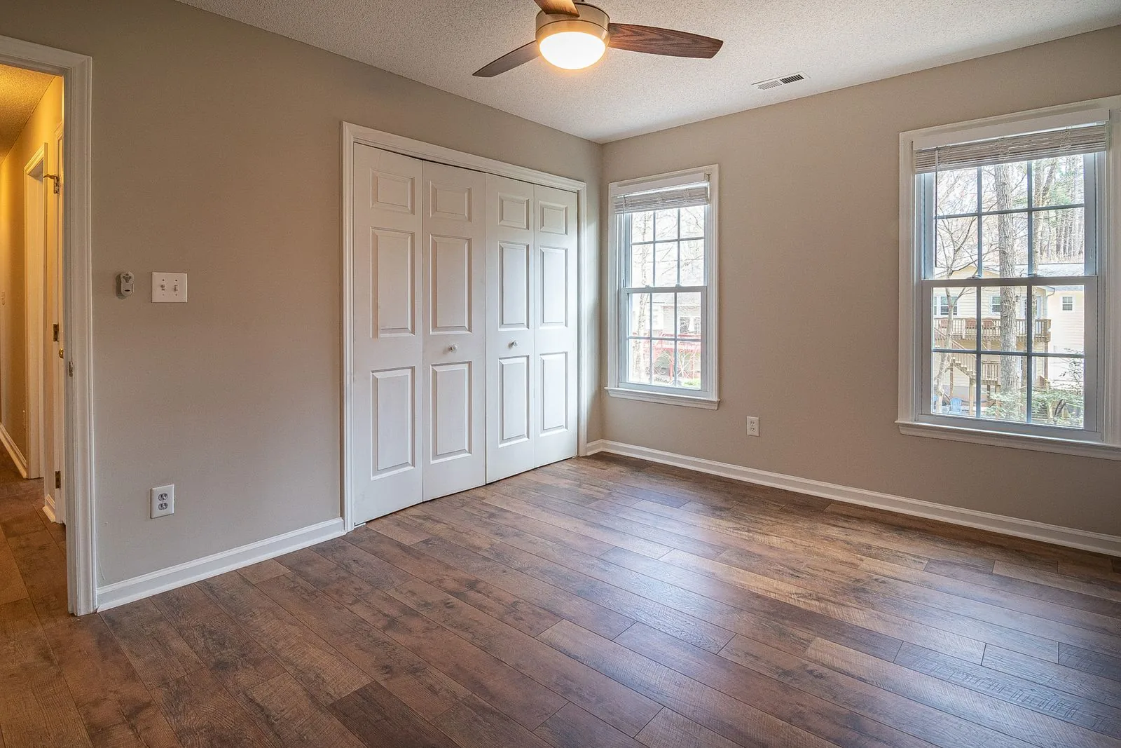 Room with newly installed hardwood flooring with natural light