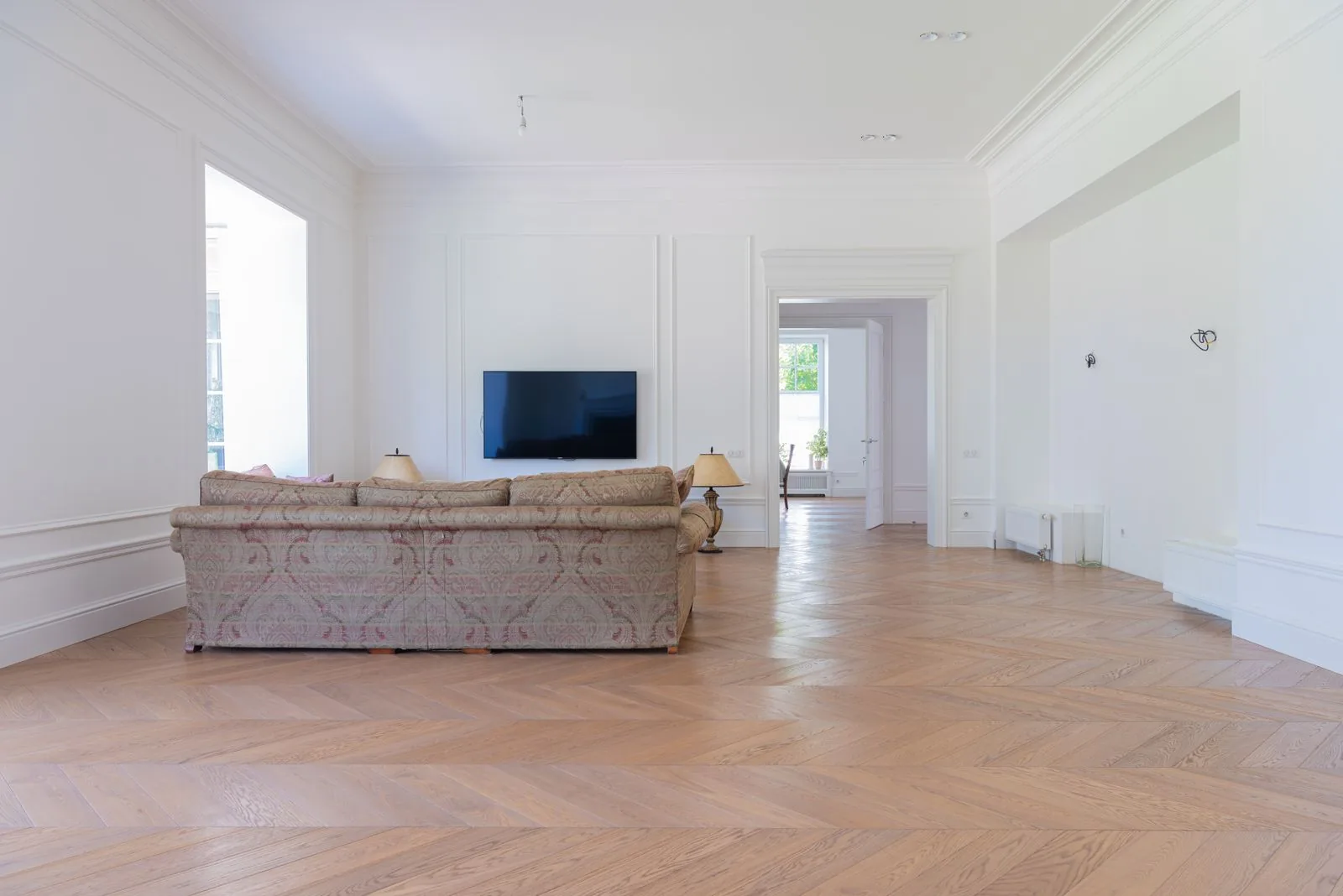 Room with newly installed hardwood flooring after a full remodel