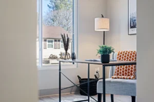Remodeled home office with a built-in desk and shelving with clean, modern finishes