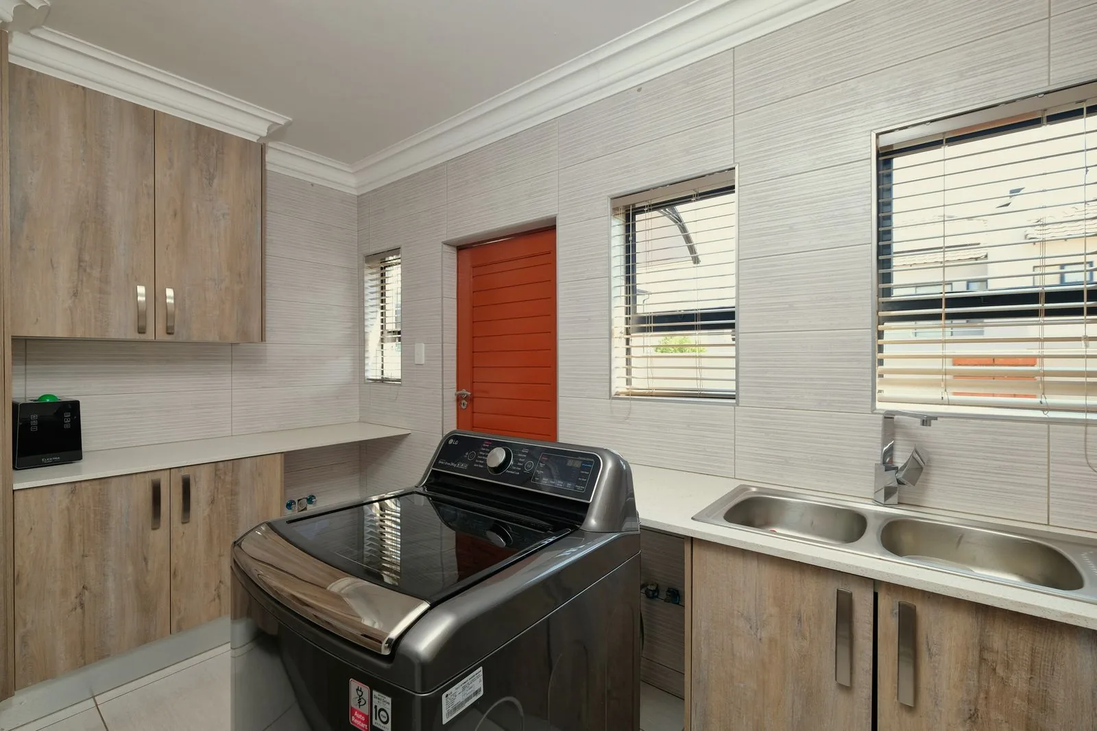 Modern remodeled laundry room with custom cabinetry after a full remodel