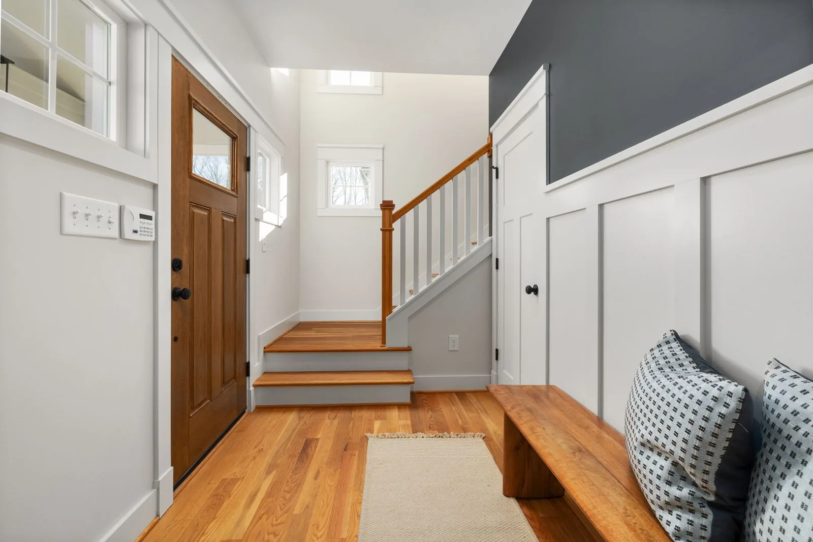 Custom mudroom with a built-in bench and lockers with premium materials