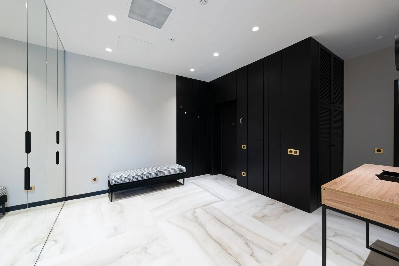 Custom mudroom with a built-in bench and lockers with clean, modern finishes