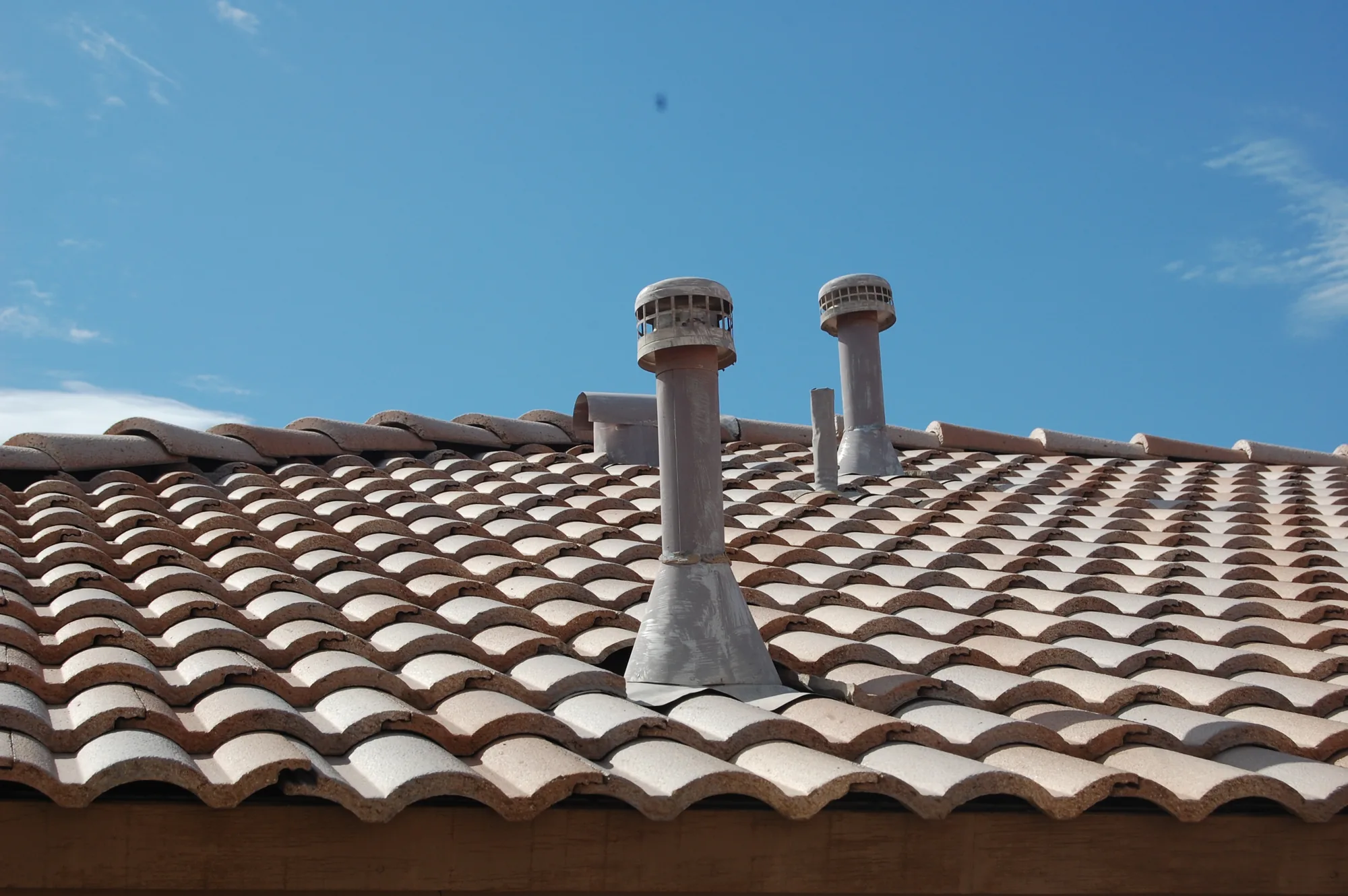 Clay tile roof with vent caps on a home