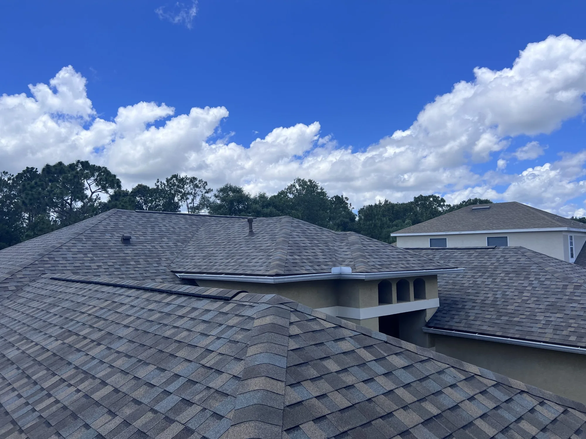 Roofline of a home against a blue sky