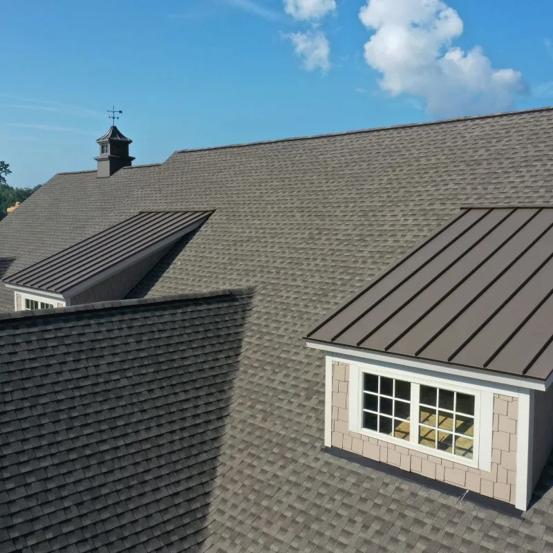 Home with a dormer and asphalt shingle roof