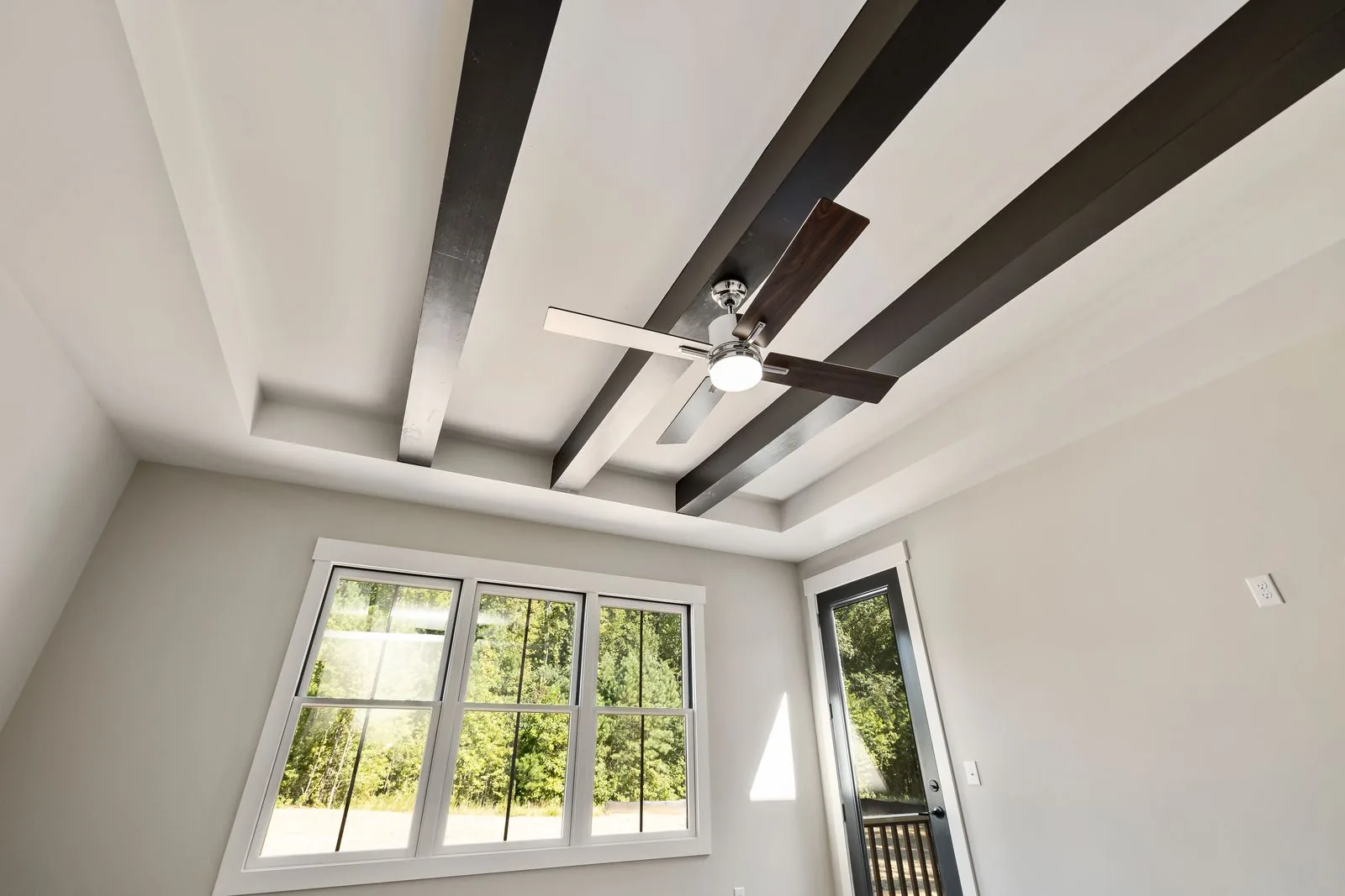 Open interior with exposed structural beams by a Bellevue-area remodeler