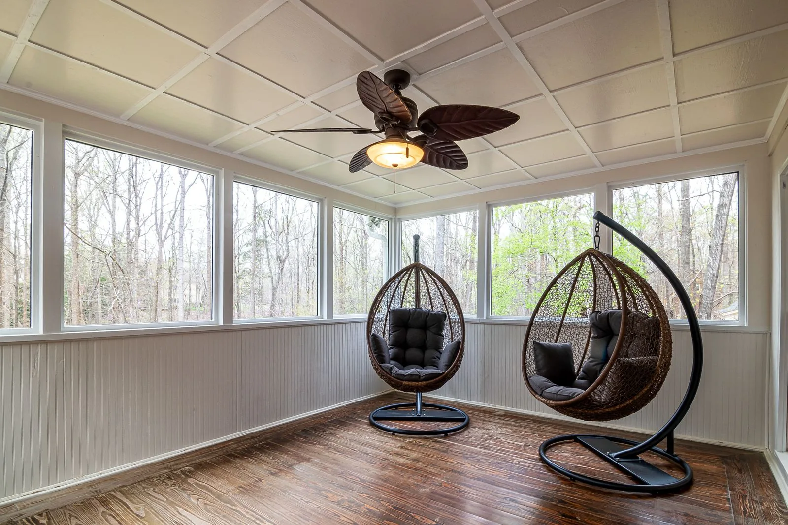 Sunroom addition with walls of glass with natural light