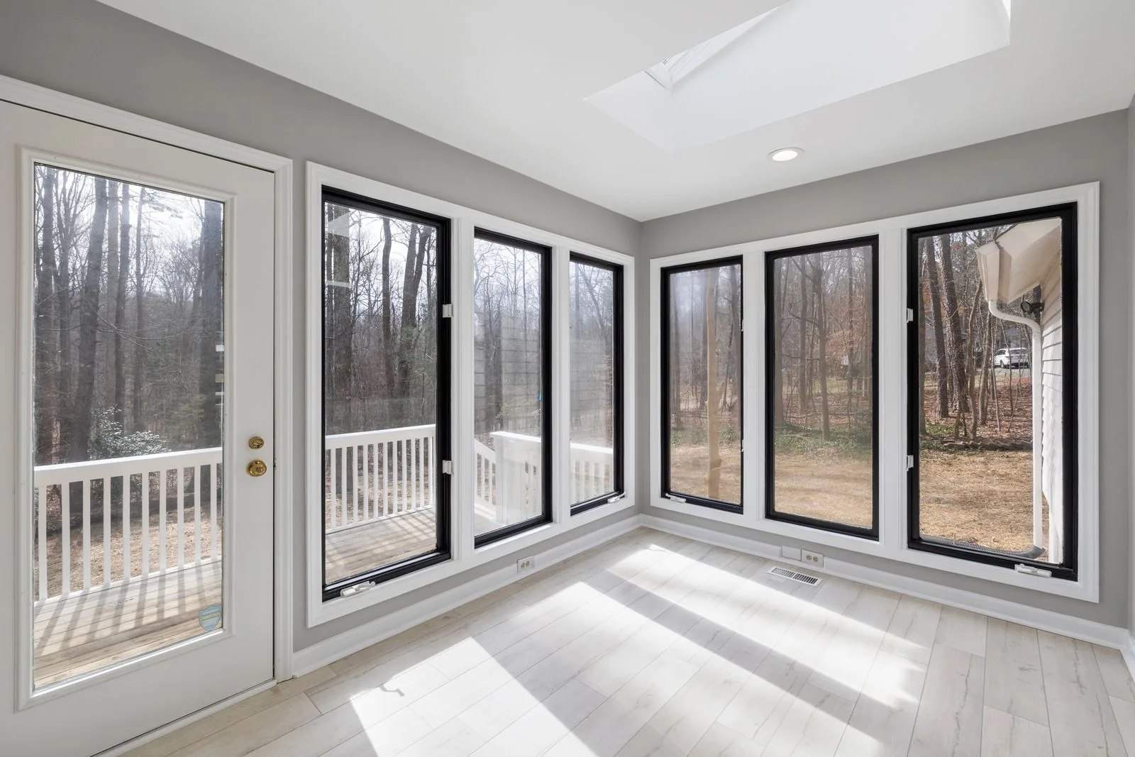 Sunroom addition with walls of glass with clean, modern finishes