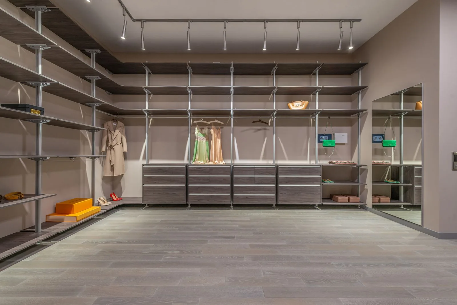 Custom walk-in closet with built-in storage with clean, modern finishes