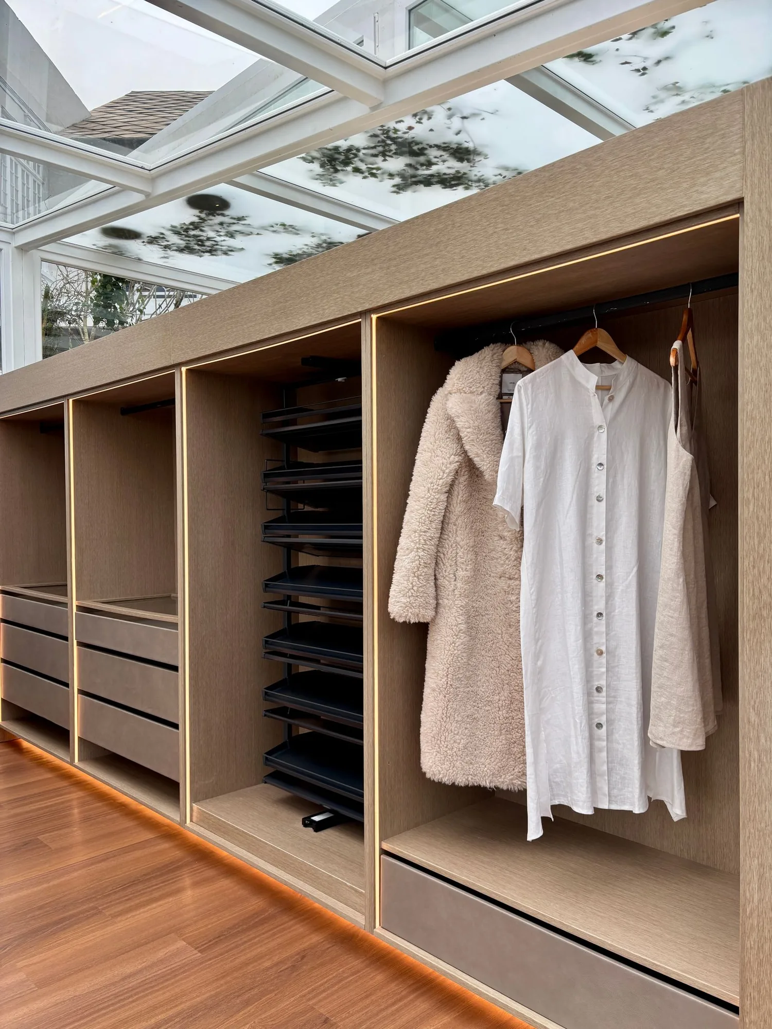 Custom walk-in closet with built-in storage with clean, modern finishes